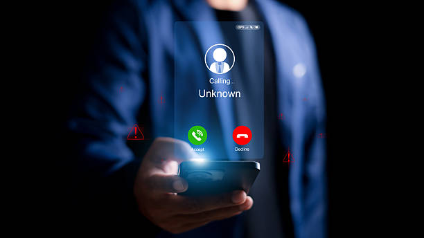 istock Unknown number displayed showing on smart mobile phone. Human use smartphone with incoming call from unknown number, spam, hacker, call center, crime, 2207431215