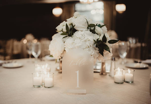 istock Wedding reception table setting with table number and flower arrangement 2207433925
