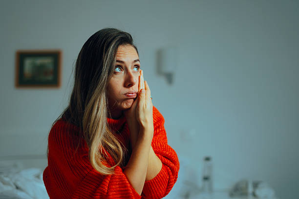 istock Woman Suffering from a Bad Toothache at Home 2207438100