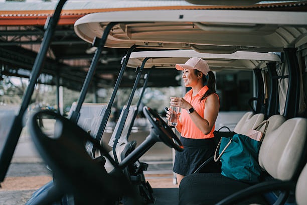 istock Asia Chinese female golfer drinking water getting ready in golf course weekend morning 2207439962