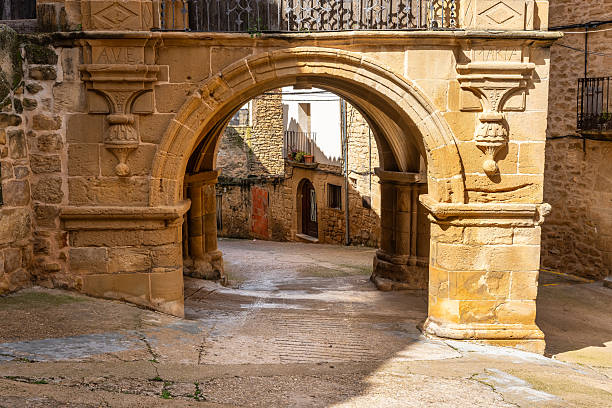 istock Stone arches in medieval buildings to circulate through the streets protected from the rain in Calaceite, Teruel. 2207445901