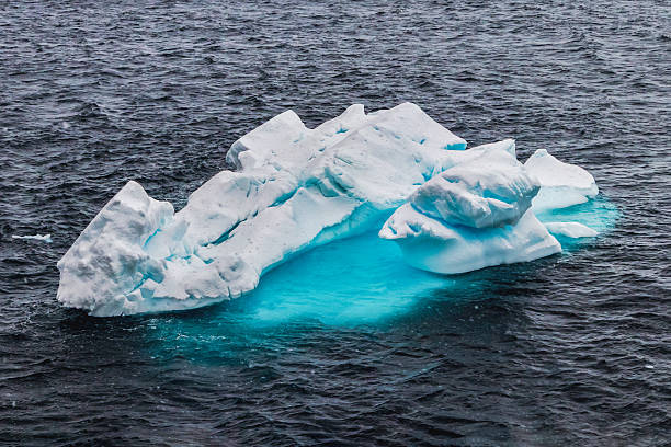 istock Iceberg floating in blue water. 2207453474