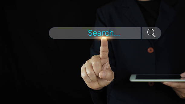 istock Businesswoman using computer laptop with search bar icon for browsing information network and SEO or search engine optimization concept. 2207454876