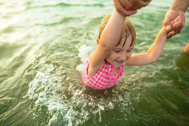 Little girl and her father swimming in the sea