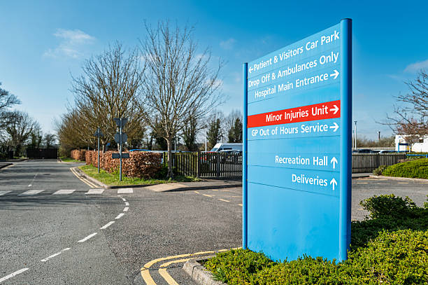 Large blue patient and visitor information and parking sign seen within the campus of a typical NHS hospital in Britain. stock photo