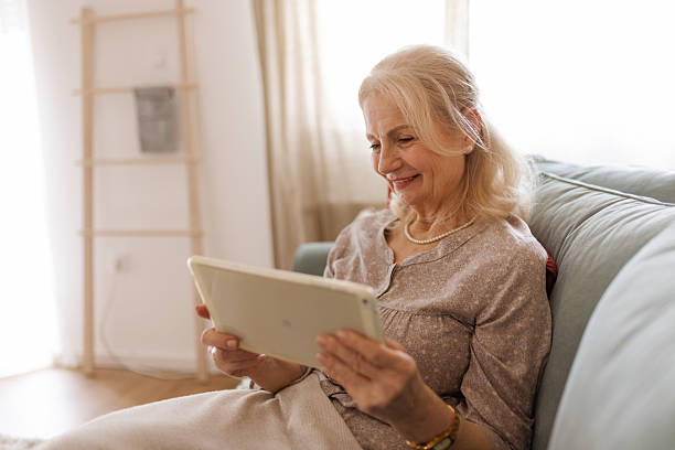 istock Cheerful Senior Lady Surfing the Internet on a Tablet 2207461552