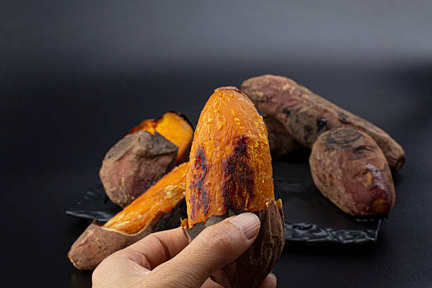 istock Roasted Sweet Potato isolated (yaki imo) on black background 2207465323