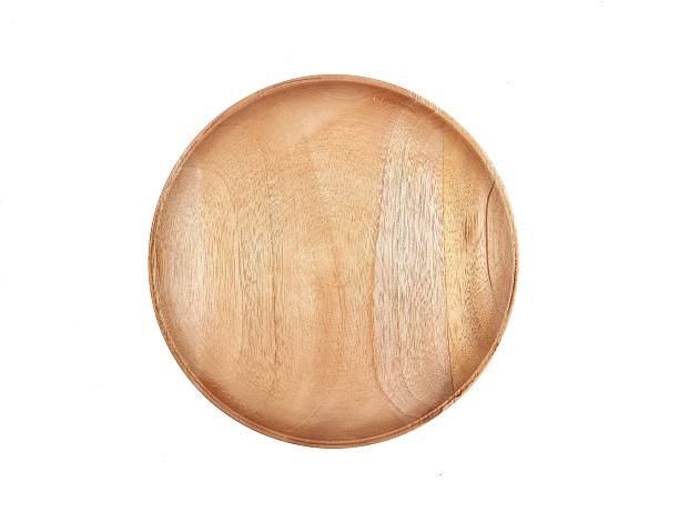istock High angle view of empty round wooden plate isolated on white background 2207465498