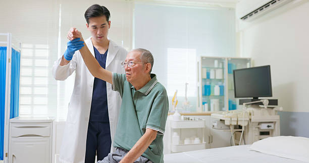 istock Asian Therapist Aids Arm Recovery 2207465874