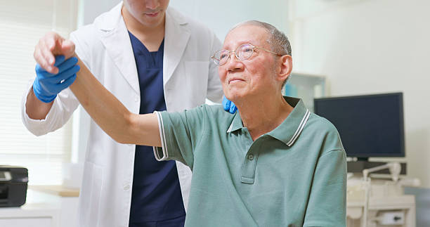 istock Asian Therapist Aids Arm Recovery 2207465888