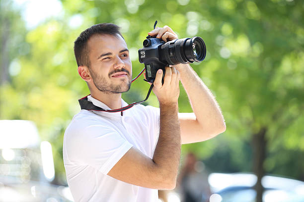 istock Young photographer with camera in the city 2207468893