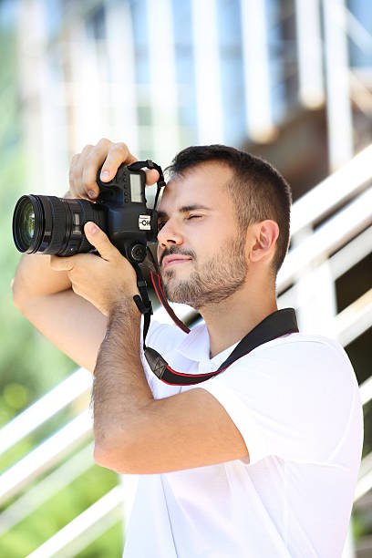 istock Young photographer with camera in the city 2207470023