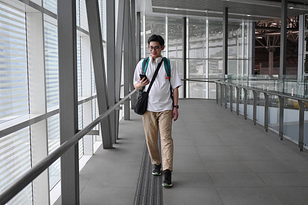 istock The man was carrying a backpack and checking the ticket information on his phone. 2207474222