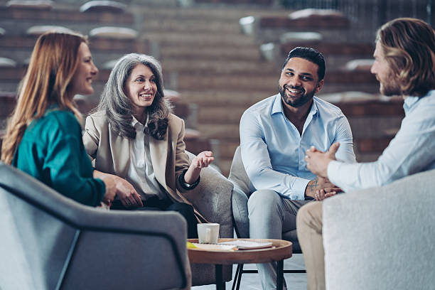 istock Group of entrepreneurs sitting around a table and talking 2207476876