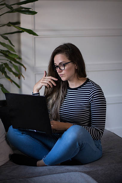 istock Young female freelancer working from home on her laptop computer. 2207478027