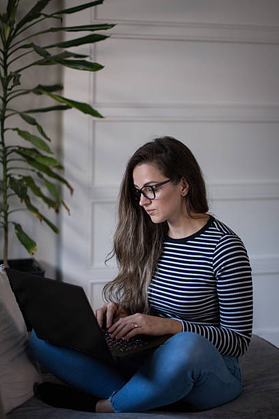 istock Young female freelancer working from home on her laptop computer. 2207478037