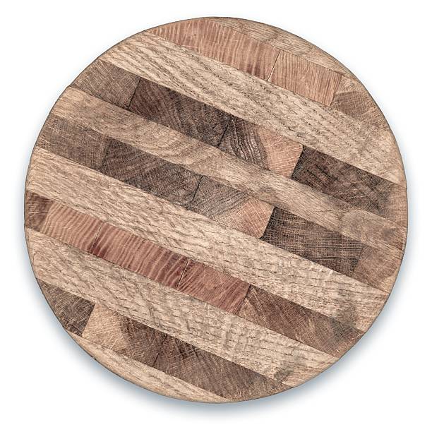 istock Round wooden cutting board with a unique pattern displayed on a white background in a well-lit kitchen setting 2207480928