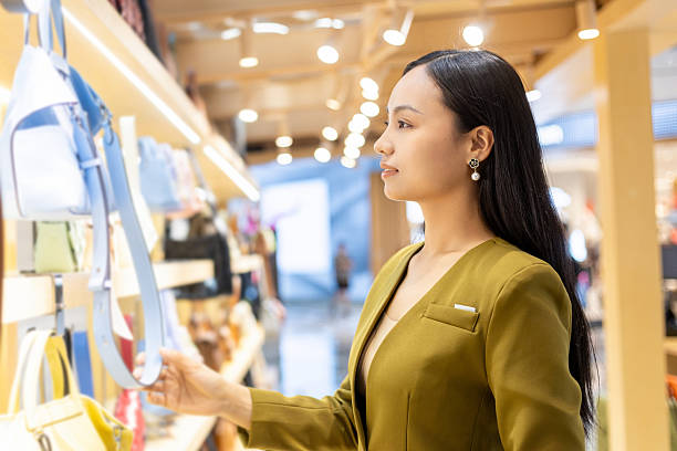 istock Young Chinese woman choosing a handbag 2207482510