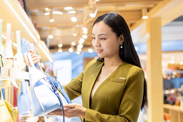 istock Young Chinese woman choosing a handbag 2207482635