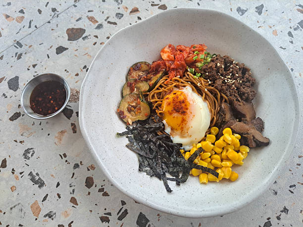 istock Fried Dry Ramen Noodle With Minced Beef, Onsen Egg, Shitake Mushroom, Corn, Nori, Kimchi, Pickled Cucumber And Spring Onion. Food Menu. 2207484157