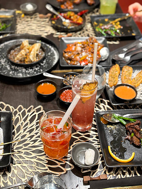 istock Image of dining experience with blue pea drink, dumplings, spring rolls, and dipping sauce / overhead view of chinese cuisine on plates 2207484406