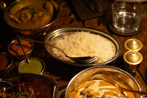 istock table covered with Indian dishes, rice in a plate close-up 2207485347