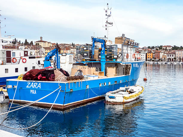 Rovinj, Istria, Croatia - February 1, 2025: Fishing boat moored in Rovinj harbor