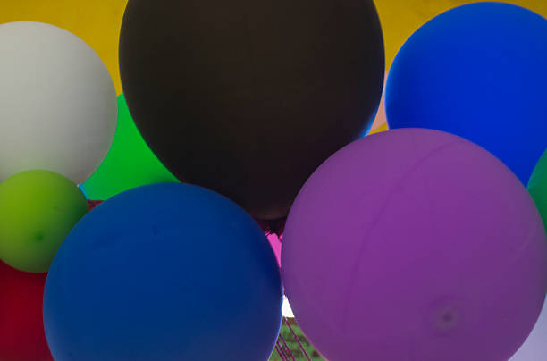 San Francisco, Cundinamarca, Colombia - August 20, 2017: It is Fiesta time in the Cundinamarca town of San Francisco in the Latin American country of Colombia. Local Colombian people are seen walking around the main town square. A couple of balloon sellers are seen with their balloons for sale. The elevation at street level is 4990 feet above mean sea level. Photo shot in the afternoon sunlight; horizontal format.