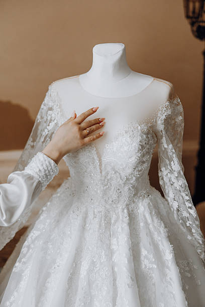 istock A woman is touching a wedding dress 2207488134