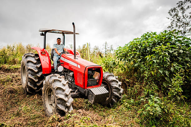 Mature man working driving a tractor at farm