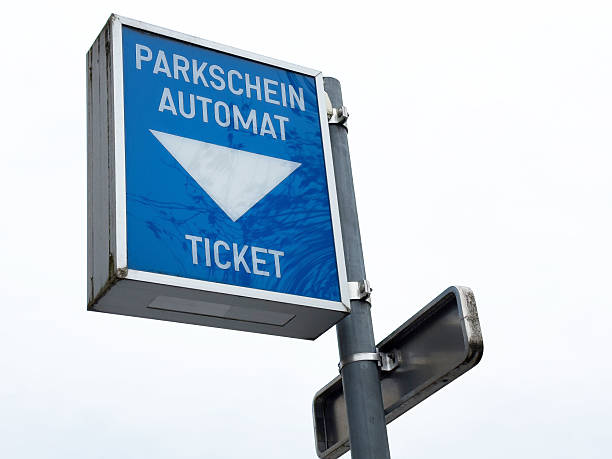 istock Blue parking ticket machine sign with arrow in urban setting 2207489417