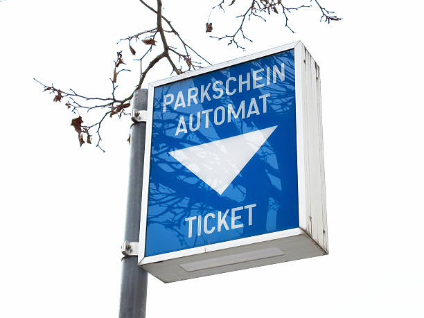 istock Blue parking ticket machine sign with white arrow on street pole 2207489438