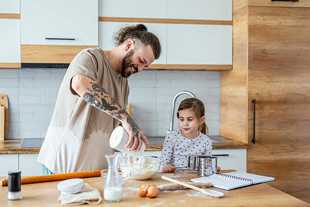 istock Father teaching his daughter how to bake cookies 2207491476