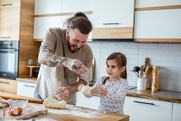 istock Father teaching his daughter how to bake cookies 2207491550