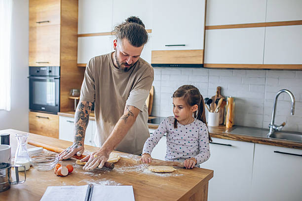 istock Happy father and daughter having fun while cooking pastry 2207492265