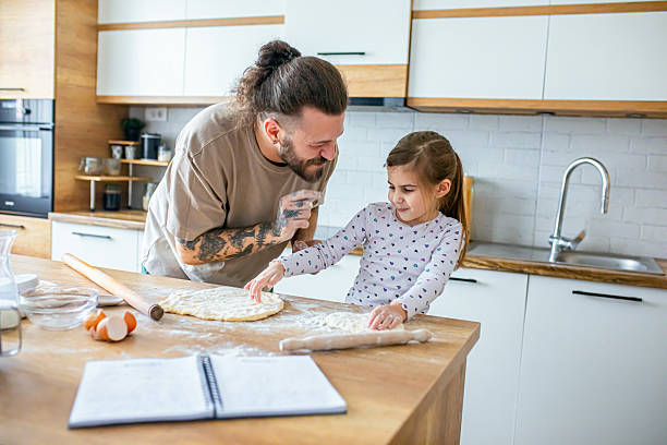 istock Happy father and daughter having fun while cooking pastry 2207492286