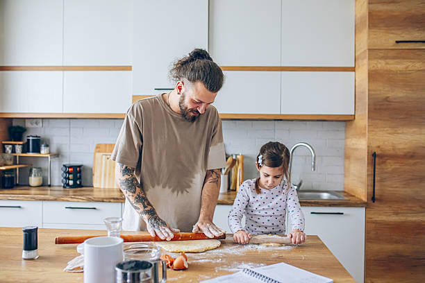 istock Happy father and daughter having fun while cooking pastry 2207492374
