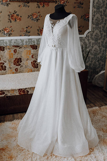 istock A long white dress with a floral pattern is displayed in a room 2207492424