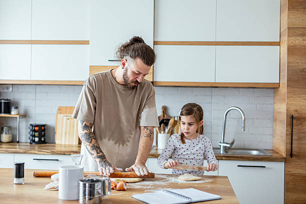 istock Happy father and daughter having fun while cooking pastry 2207492535