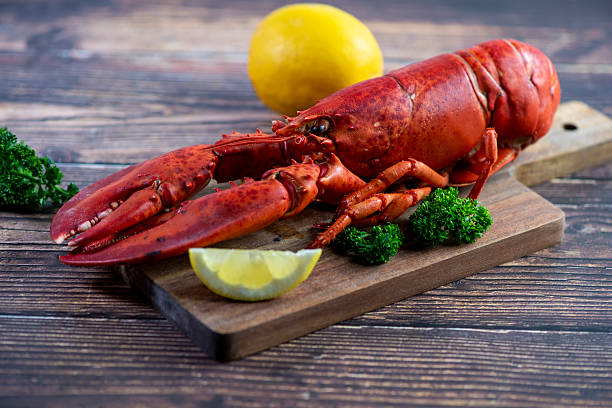 istock Red lobster on wooden cutting board 2207495012