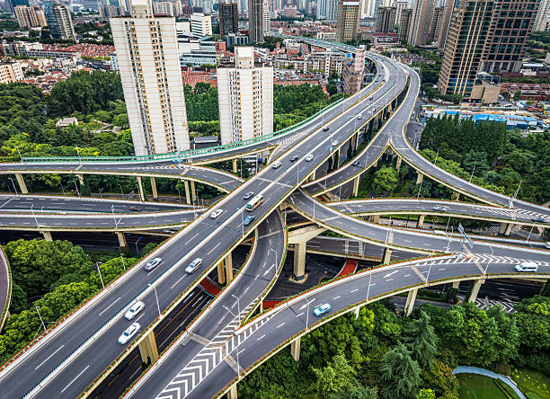 istock Complex overpass road system intertwining amid the modern buildings and lush trees in Shanghai 2207495456