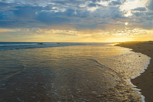 istock Soft light reflects on the shoreline as evening falls on a tranquil beach. 2207504730