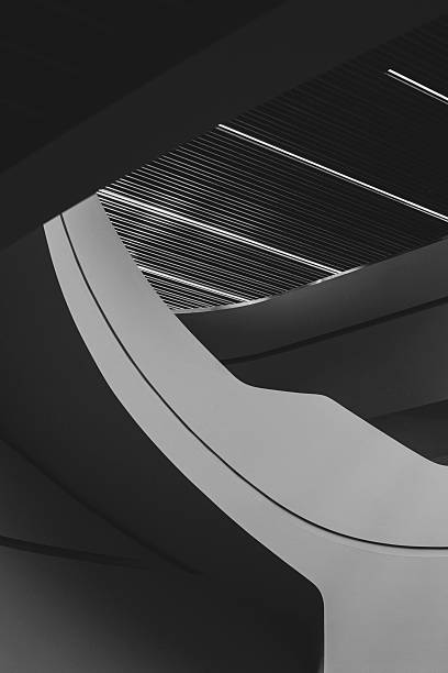 istock Modern architectural curves and light contrasts in monochrome. Abstract interior design with flowing lines and illuminated ceiling. 2207505332