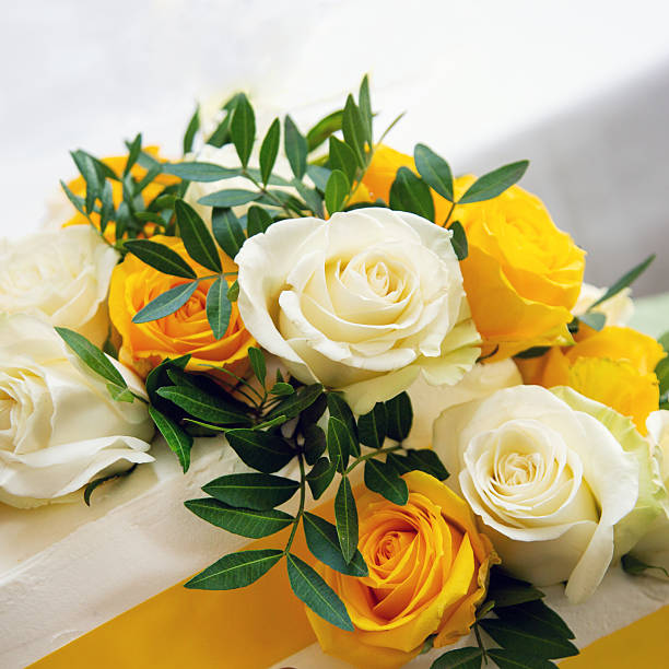 Arrangement of white and yellow roses