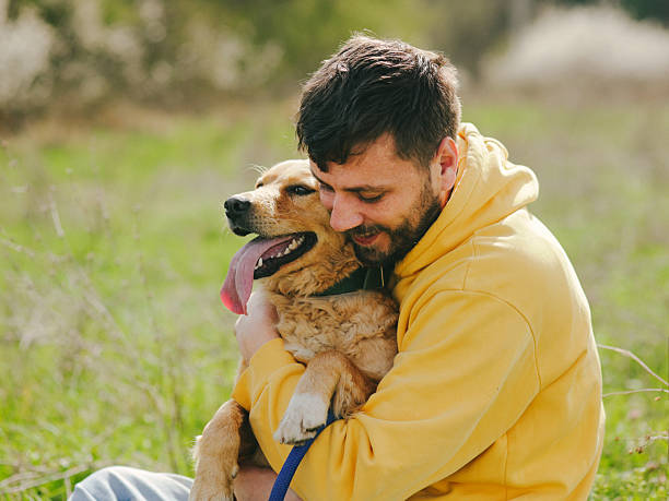 istock Guy and his dog, golden retriever, nature 2207511438
