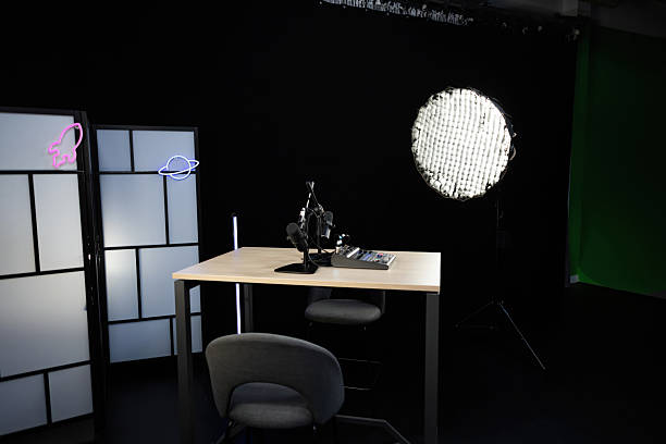 istock Podcast studio setup featuring microphones, mixer, and green screen 2207519238