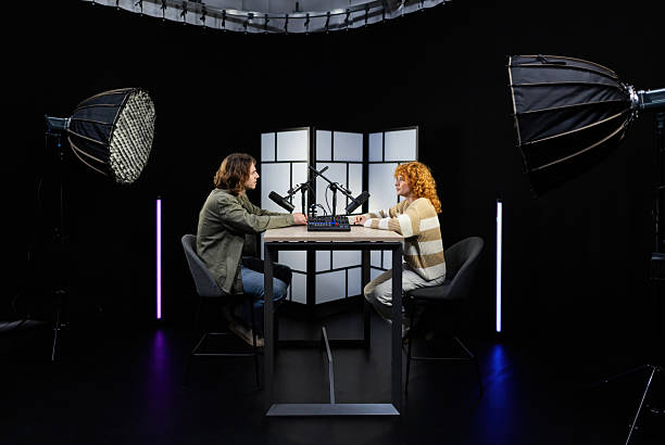 istock Two content creators recording a podcast in professional studio 2207519356
