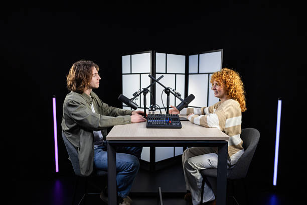 istock Two content creators recording a podcast in a professional studio 2207519926