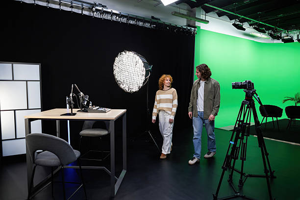 istock Podcasters walking in professional recording studio with green screen 2207520069