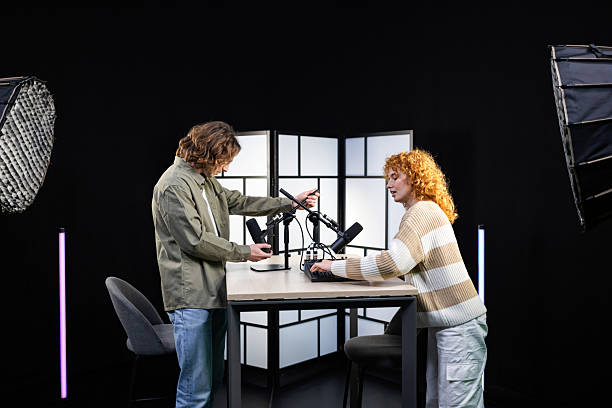 istock Podcasters preparing microphones and sound mixer in recording studio 2207520209